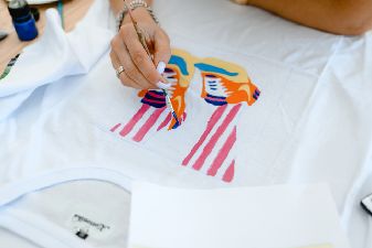 httpselements.envato.coma-woman-sits-at-a-table-and-paints-a-fashionable-p-FQXJVZD.jpg