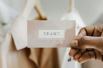 httpselements.envato.comhand-holding-business-card-at-a-boutique-3U8NF86.jpg